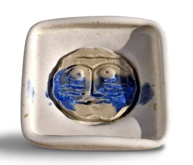 a ceramic plate with a face on it Mandiola